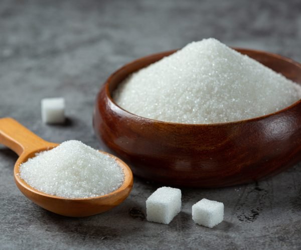 World diabetes day; sugar in wooden bowl on dark background